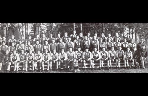 The Bearcat Football team poses for a group picture.  Milner's coaching record at Northwest was 92 wins, 61 losses, and 13 ties.