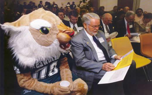 During Northwest Day at the Missouri Legislature in Jefferson City in 2004, President Dean Hubbard consults his notes as Bobby Bearcat looks on.