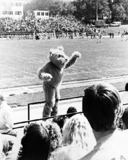 Bobby helps with school spirit during a 1977 football game, urging the crowd to cheer for the Bearcats.