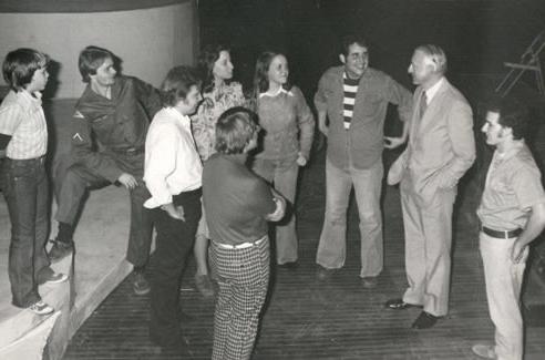 President 欧文斯 talks with student theater majors on the stage at the Charles Johnson Theater in the Olive DeLuce Fine Arts Building.